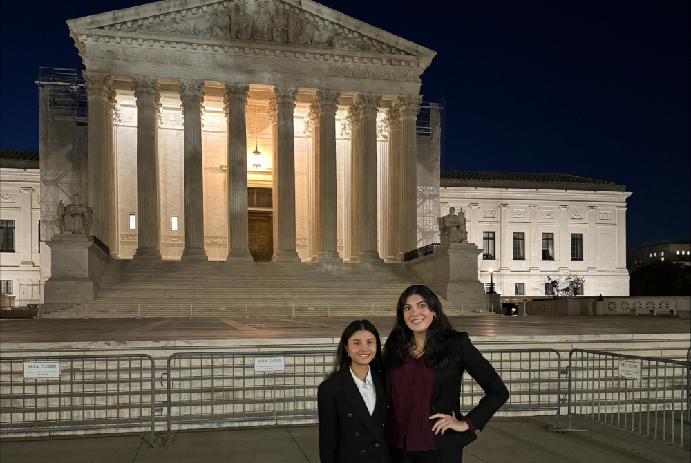 two students in front of the building of the Supreme Court of the United States