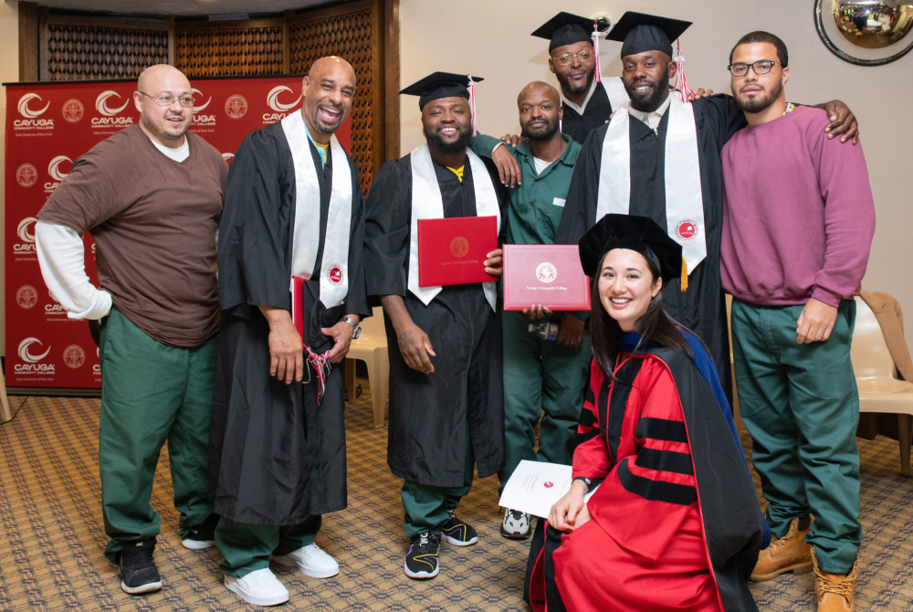 group of graduates with faculty member in regalia