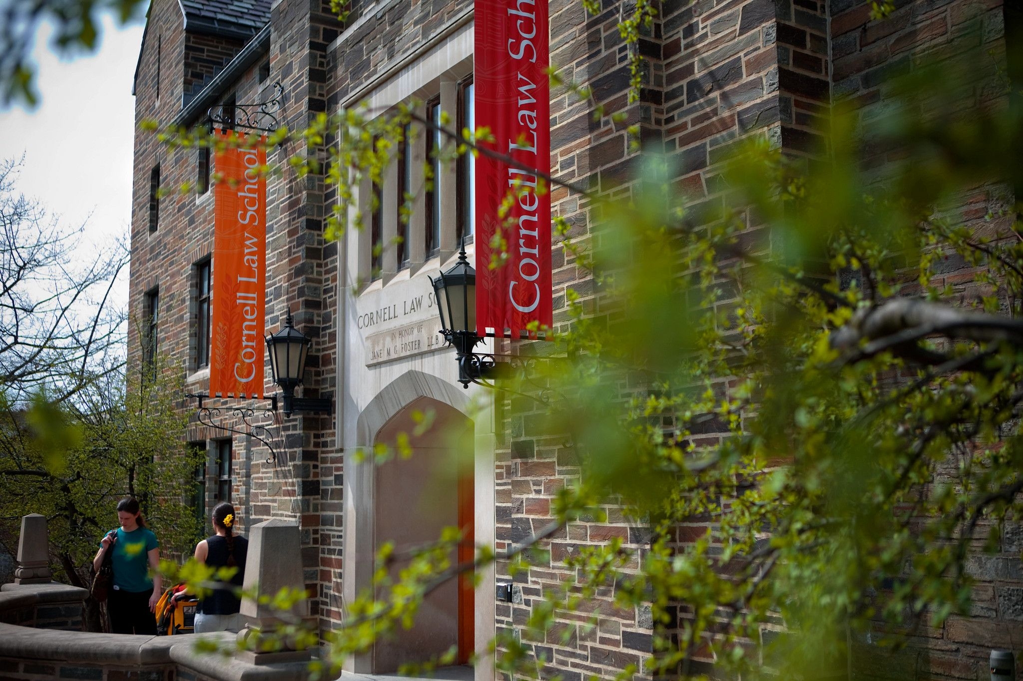 Campus building with red and orange banners that read 