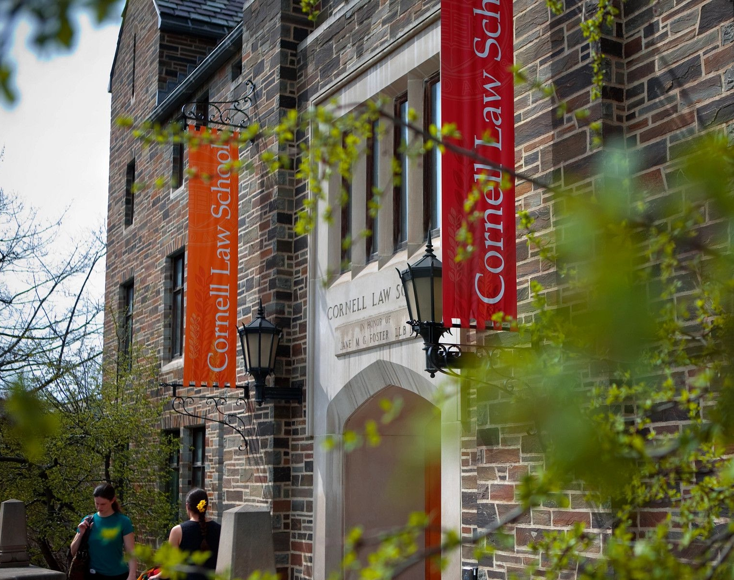 Campus building with red and orange banners that read 