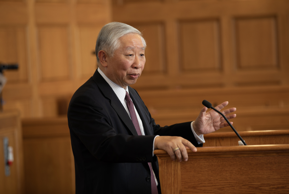 Jonathan Zhu giving his lecture at podium in Moot Court Room at Cornell Law School