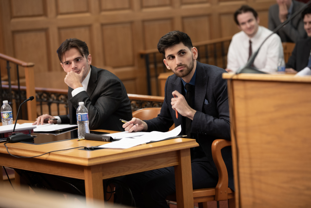 Alan Hakki '26 (right) and Brian Hartan '26 (left) listening to arguments. 