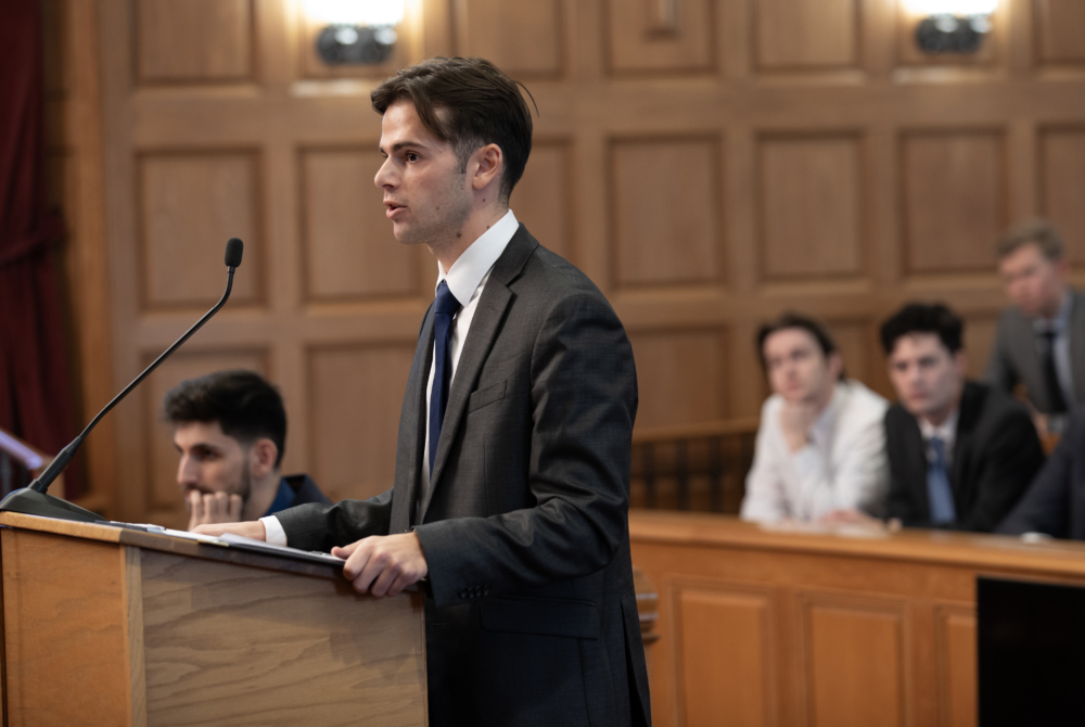 Brian Hartan '26 arguing his case in front of the judging panel. 