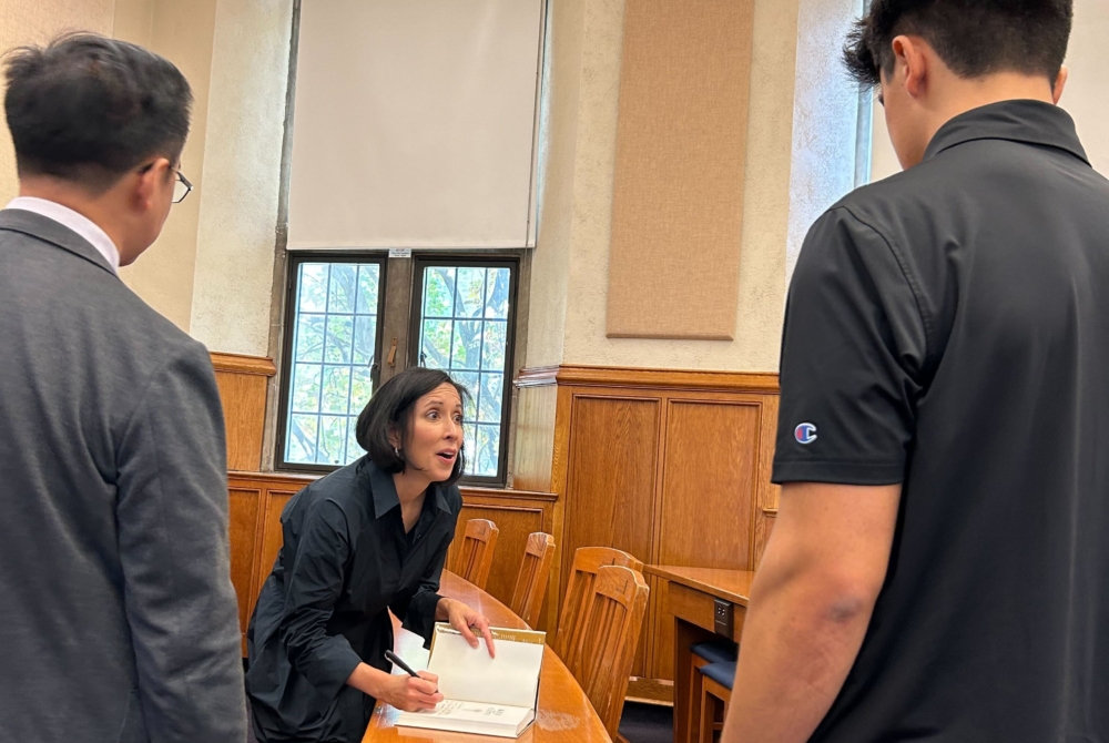 Sara Bronin signing a copy of her book for a student