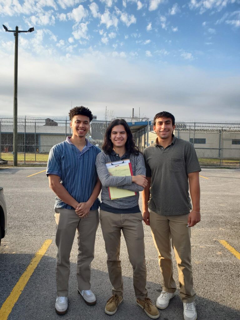 three students outside a detention center